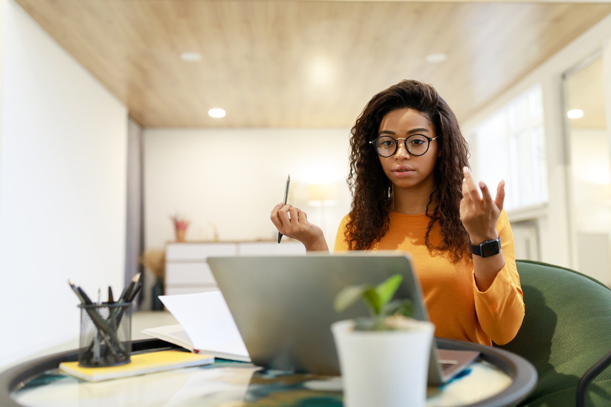 Black woman having video call using laptop and talking